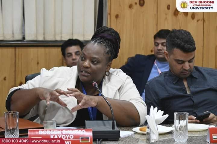Malawian participant speaking during a university discussion in India