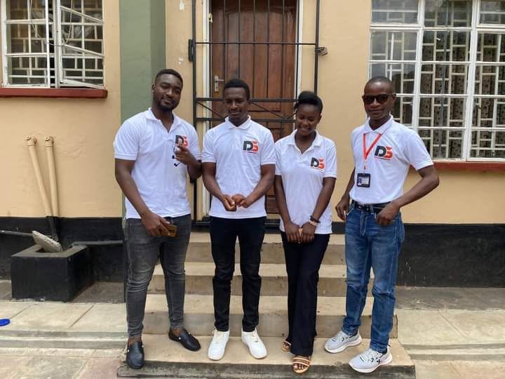 Discom-branded team members outside a building